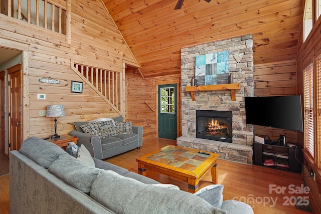 59 Valley Hts, Mars Hill, NC 28754 - living room with lofted ceiling, wood walls, wood finished floors, a stone fireplace, and wood ceiling