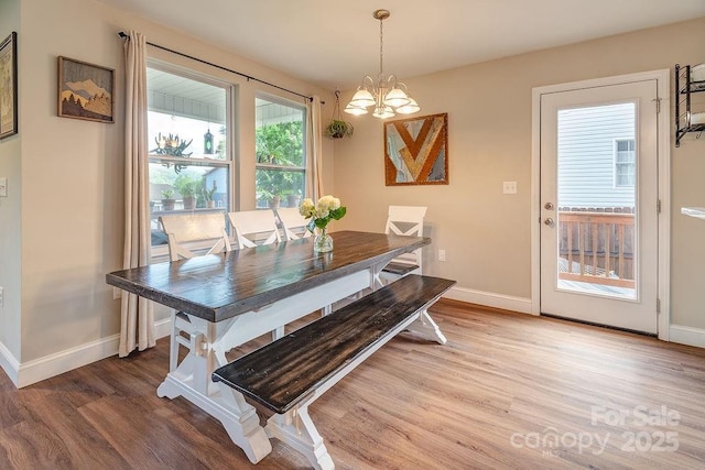 10 Half Moon Dr, Swannanoa, NC 28778 - dining space with an inviting chandelier, baseboards, and wood finished floors
