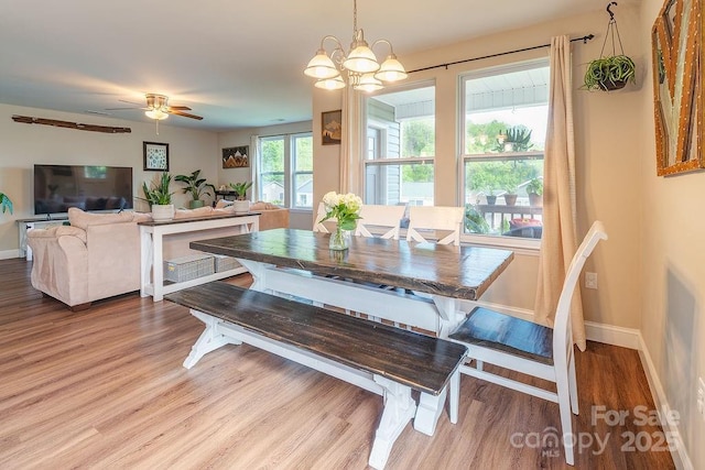 10 Half Moon Dr, Swannanoa, NC 28778 - dining space with baseboards, wood finished floors, and ceiling fan with notable chandelier