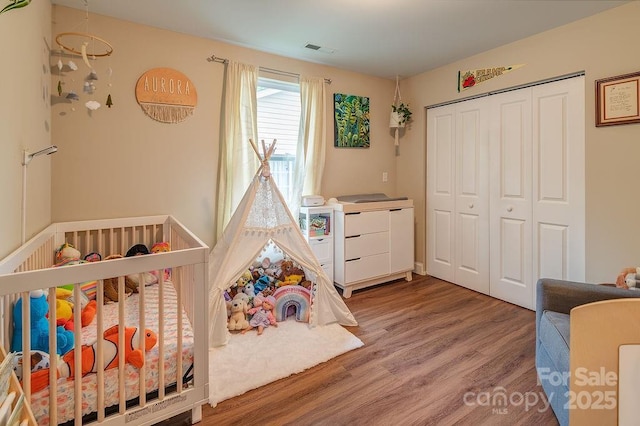 10 Half Moon Dr, Swannanoa, NC 28778 - bedroom with a closet, a nursery area, wood finished floors, and visible vents