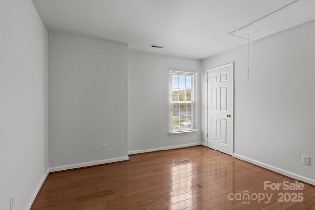150 Pleasant Grove Ln, Mooresville, NC 28115 - spare room featuring baseboards, attic access, wood finished floors, and visible vents