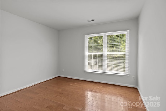 150 Pleasant Grove Ln, Mooresville, NC 28115 - empty room featuring visible vents, baseboards, and hardwood / wood-style floors