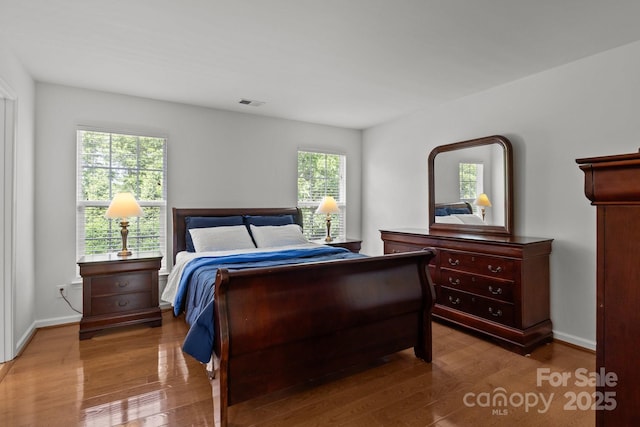 150 Pleasant Grove Ln, Mooresville, NC 28115 - bedroom featuring baseboards, wood finished floors, and visible vents