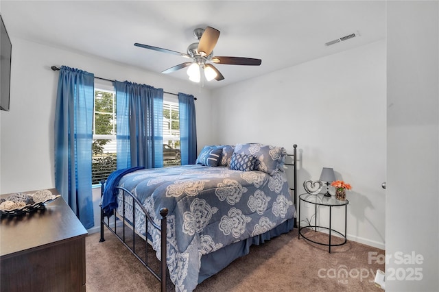 bedroom featuring visible vents, carpet flooring, and a ceiling fan