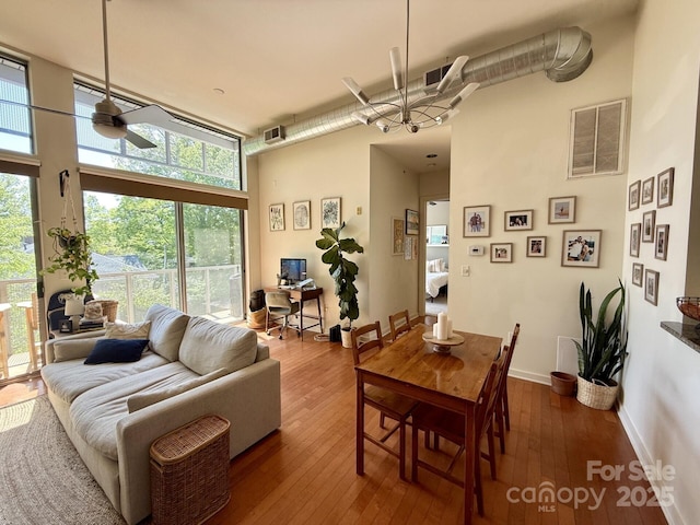 2116 Mcclintock Rd Unit 123, Charlotte, NC 28205 - dining area with visible vents, wood-type flooring, ceiling fan, and a high ceiling