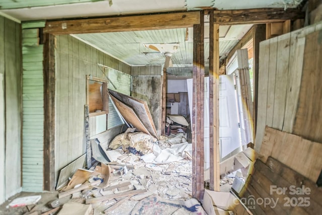 misc room featuring wood walls