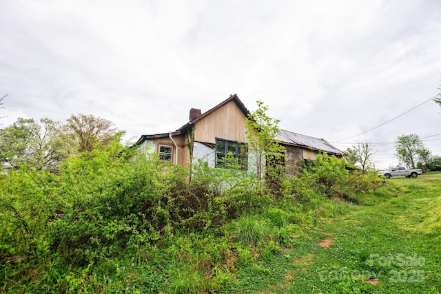 view of property exterior with a chimney
