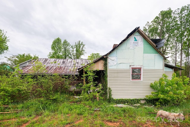 view of side of property featuring metal roof