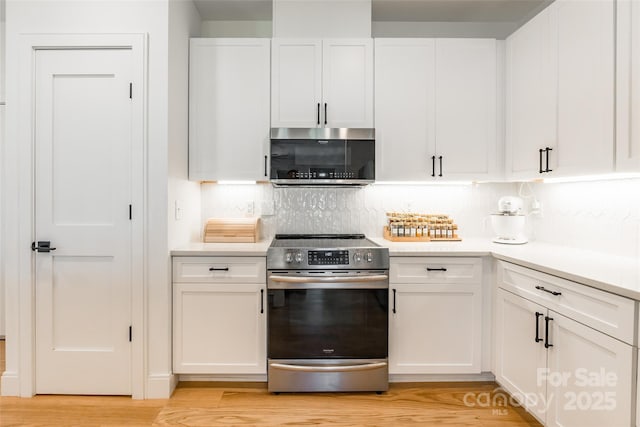 kitchen with light countertops, appliances with stainless steel finishes, and white cabinets