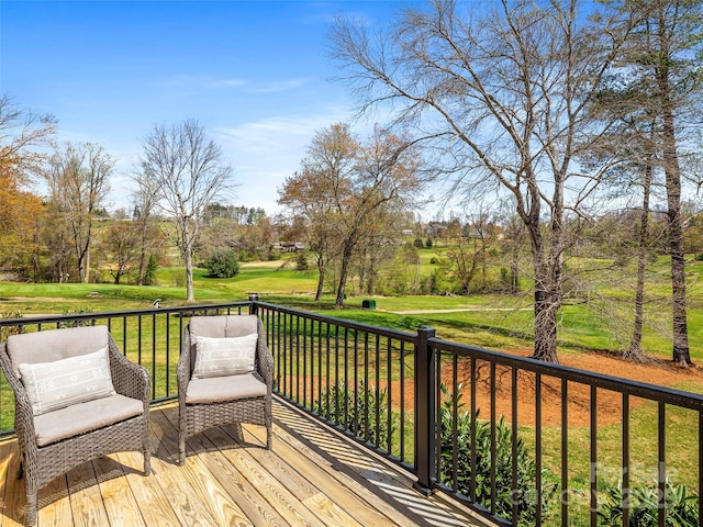 wooden deck featuring a yard