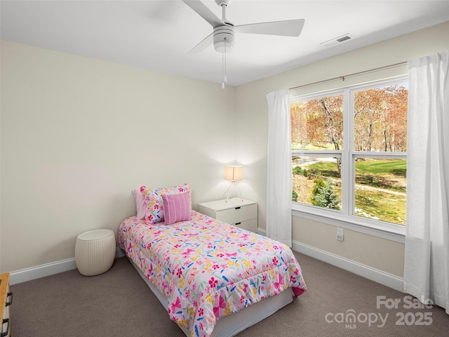 carpeted bedroom featuring baseboards, multiple windows, ceiling fan, and visible vents