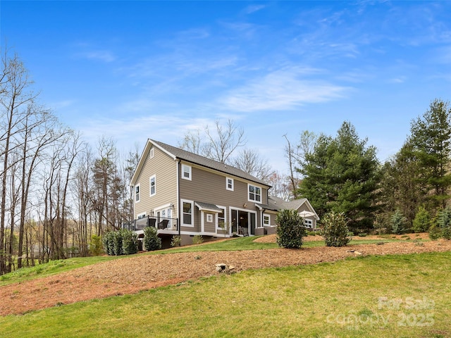 rear view of property featuring a yard