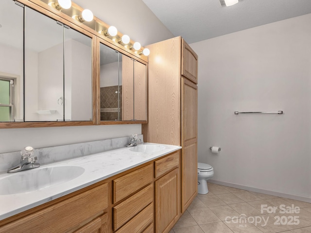full bathroom with tile patterned flooring, a sink, double vanity, and toilet