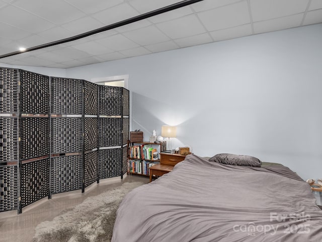 carpeted bedroom with a drop ceiling
