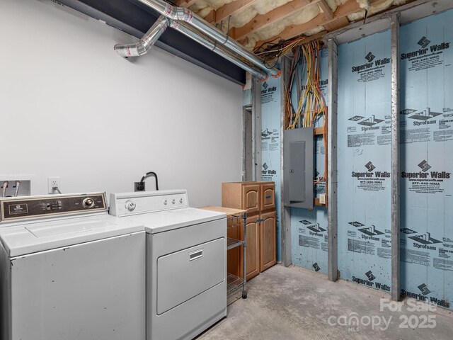 washroom featuring washing machine and dryer and electric panel