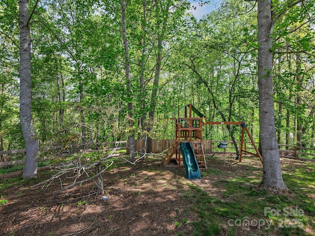 view of jungle gym featuring fence