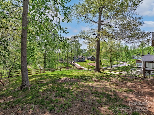 view of yard with a deck and fence