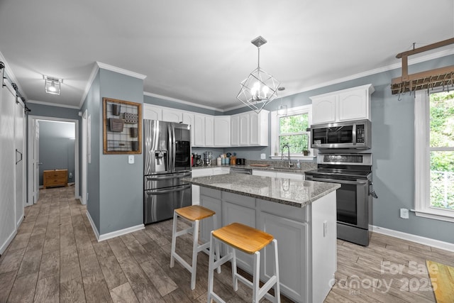 215 Calm Creek Rd, Fletcher, NC 28732 - kitchen with stainless steel appliances, white cabinetry, ornamental molding, light stone counters, and baseboards