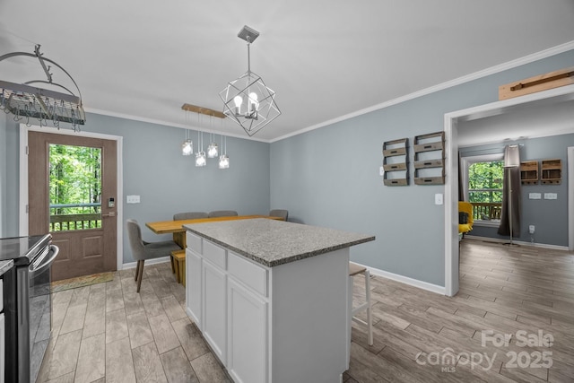 215 Calm Creek Rd, Fletcher, NC 28732 - kitchen with a chandelier, light wood-style floors, white cabinets, healthy amount of natural light, and crown molding
