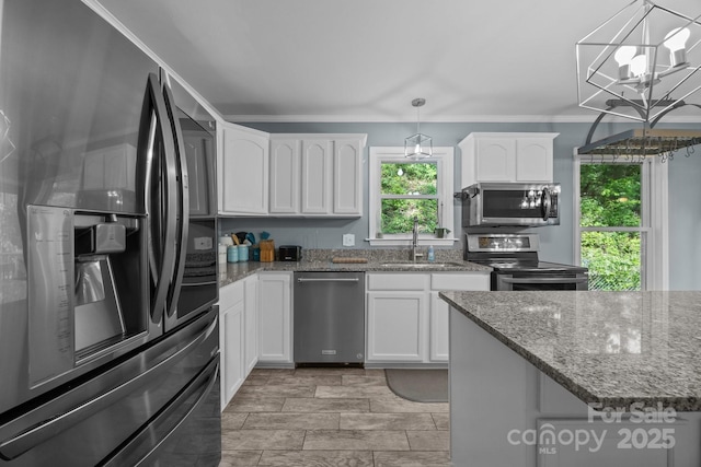 215 Calm Creek Rd, Fletcher, NC 28732 - kitchen featuring stainless steel appliances, a sink, white cabinets, stone countertops, and decorative light fixtures