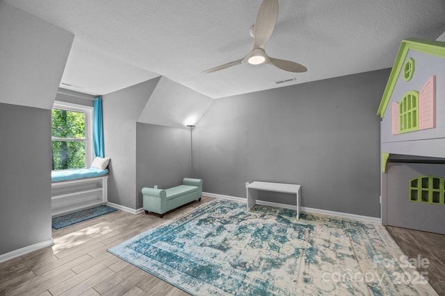 215 Calm Creek Rd, Fletcher, NC 28732 - additional living space with a textured ceiling, wood finished floors, a ceiling fan, baseboards, and lofted ceiling