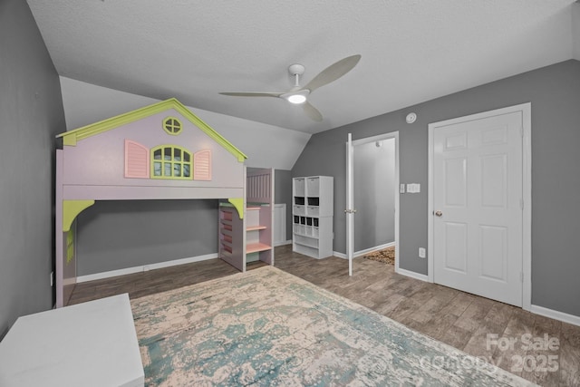 215 Calm Creek Rd, Fletcher, NC 28732 - bedroom with vaulted ceiling, wood finished floors, a textured ceiling, baseboards, and ceiling fan