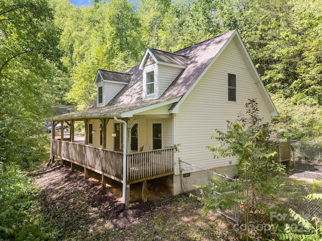 215 Calm Creek Rd, Fletcher, NC 28732 - view of side of home featuring covered porch, a forest view, a shingled roof, and crawl space