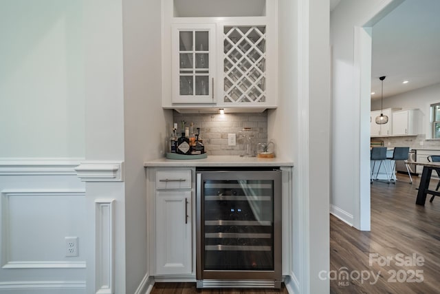 1107 Castle Rd, Indian Land, SC 29707 - indoor dry bar with wine cooler, tasteful backsplash, dark wood-style flooring, and baseboards