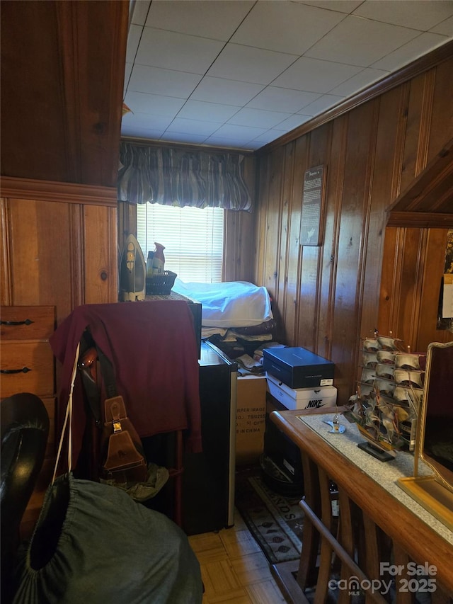 bedroom featuring wood walls