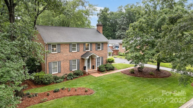 1209 Alfred St, Charlotte, NC 28211 - colonial home featuring a chimney, a front lawn, brick siding, and a shingled roof