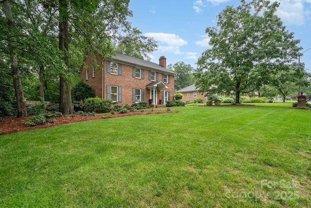 1209 Alfred St, Charlotte, NC 28211 - colonial house with a chimney, a front lawn, and brick siding