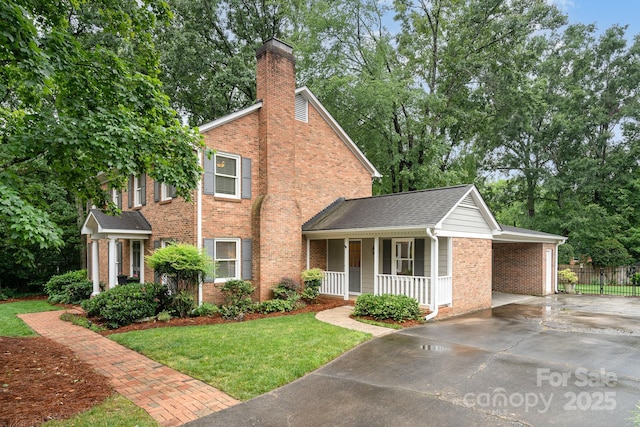 1209 Alfred St, Charlotte, NC 28211 - view of front of property featuring concrete driveway, a porch, brick siding, a chimney, and an attached carport