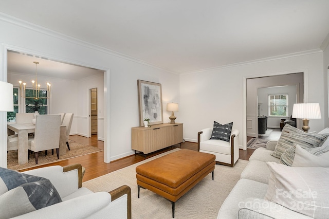 1209 Alfred St, Charlotte, NC 28211 - living area featuring a chandelier, ornamental molding, wood finished floors, and baseboards