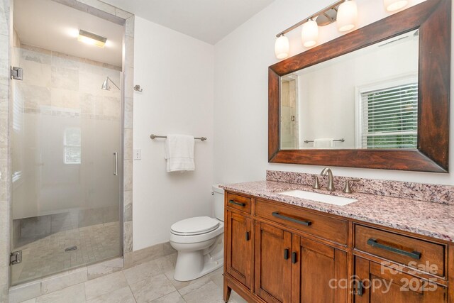 1209 Alfred St, Charlotte, NC 28211 - bathroom featuring vanity, a shower stall, toilet, and tile patterned flooring