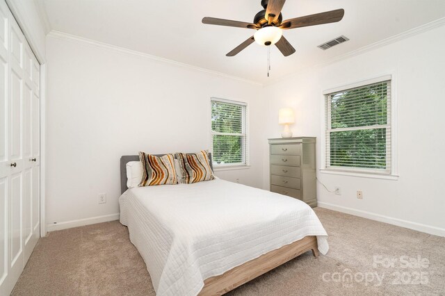 1209 Alfred St, Charlotte, NC 28211 - bedroom featuring ornamental molding, light carpet, baseboards, a closet, and ceiling fan