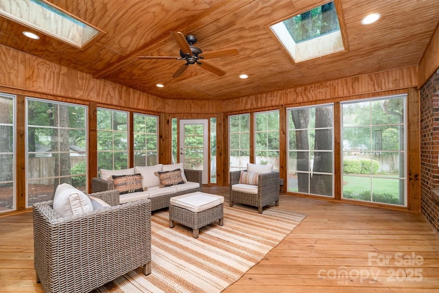 1209 Alfred St, Charlotte, NC 28211 - living room featuring a skylight, wooden ceiling, ceiling fan, wooden walls, and light wood-style floors