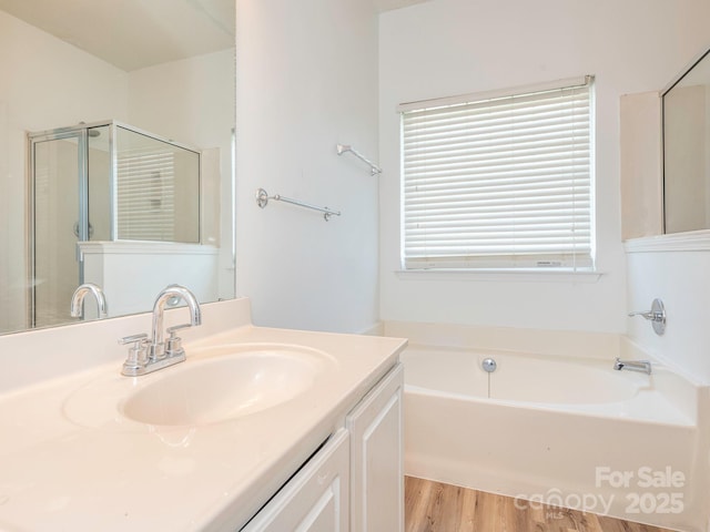 6212 Derryfield Dr, Charlotte, NC 28213 - bathroom featuring vanity, a bath, wood finished floors, and a shower with shower door