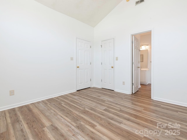 6212 Derryfield Dr, Charlotte, NC 28213 - unfurnished bedroom featuring light wood-style floors, high vaulted ceiling, and ensuite bathroom