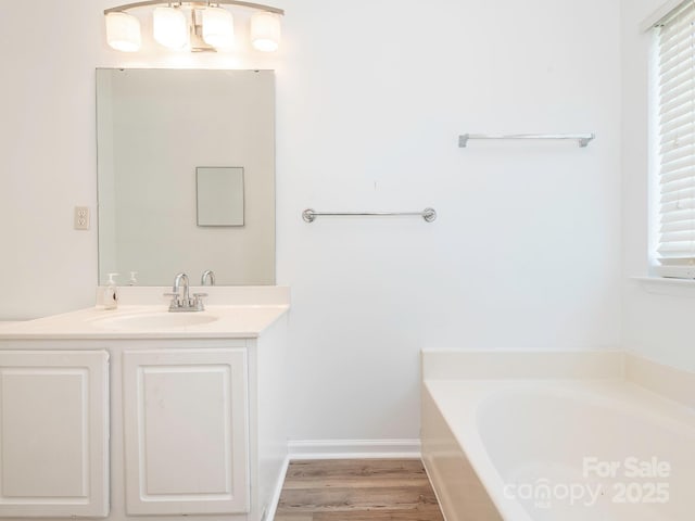 6212 Derryfield Dr, Charlotte, NC 28213 - bathroom featuring a bath, vanity, and wood finished floors