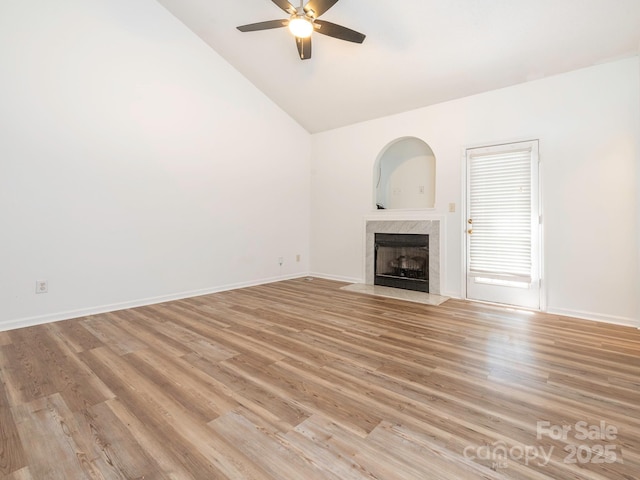 6212 Derryfield Dr, Charlotte, NC 28213 - unfurnished living room featuring a premium fireplace, ceiling fan, light wood-type flooring, and high vaulted ceiling
