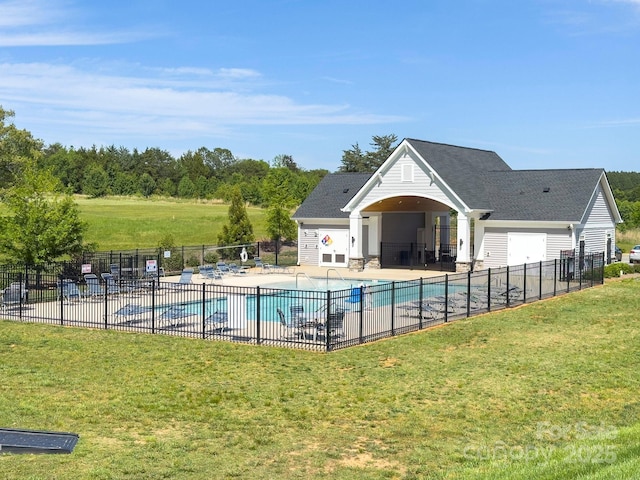 community pool with fence, a patio, and a yard