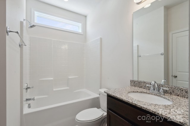 bathroom with vanity, bathtub / shower combination, and toilet