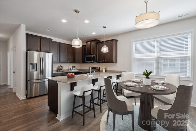 4527 Dover Ct, Denver, NC 28037 - kitchen with visible vents, a peninsula, dark brown cabinets, dark wood finished floors, and appliances with stainless steel finishes