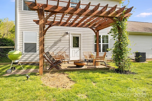 rear view of property featuring central AC unit, a yard, a pergola, and a patio