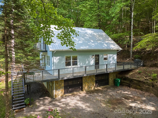 14 Leisure Ln, Weaverville, NC 28787 - rear view of house featuring a metal roof, stairway, stone siding, a garage, and driveway