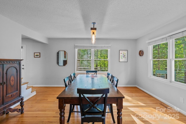 14 Leisure Ln, Weaverville, NC 28787 - dining area with plenty of natural light, light wood-type flooring, stairway, and a textured ceiling