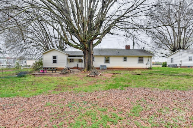 6323 Wilora Lake Rd, Charlotte, NC 28212 - back of property featuring a chimney, a yard, and central AC