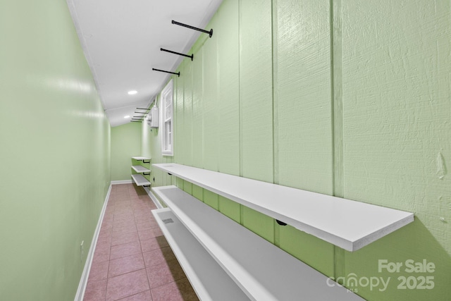corridor with tile patterned floors, baseboards, and recessed lighting