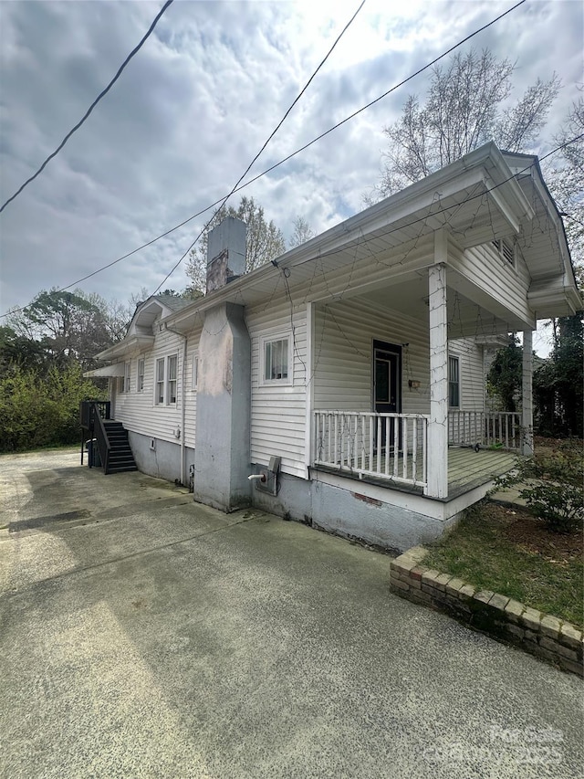 2511 Chapel Hill Rd, Durham, NC 27707 - view of side of property featuring covered porch and a chimney
