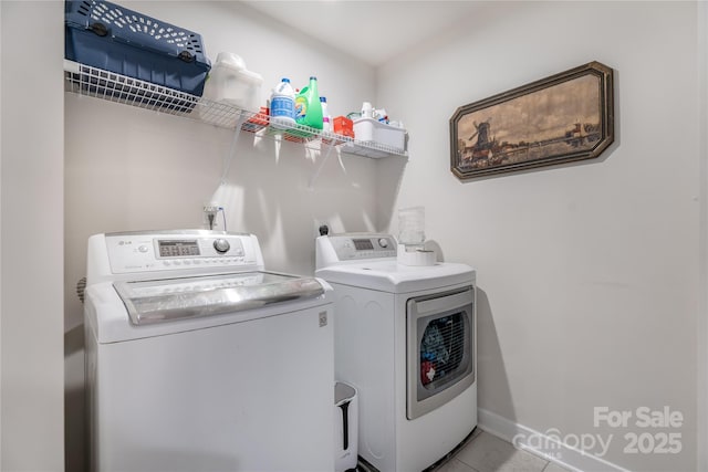 laundry room featuring washer and dryer, laundry area, and tile patterned flooring
